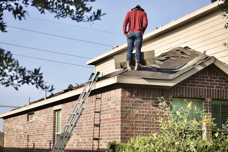 Professional roofer working on a residential roof in Porterville